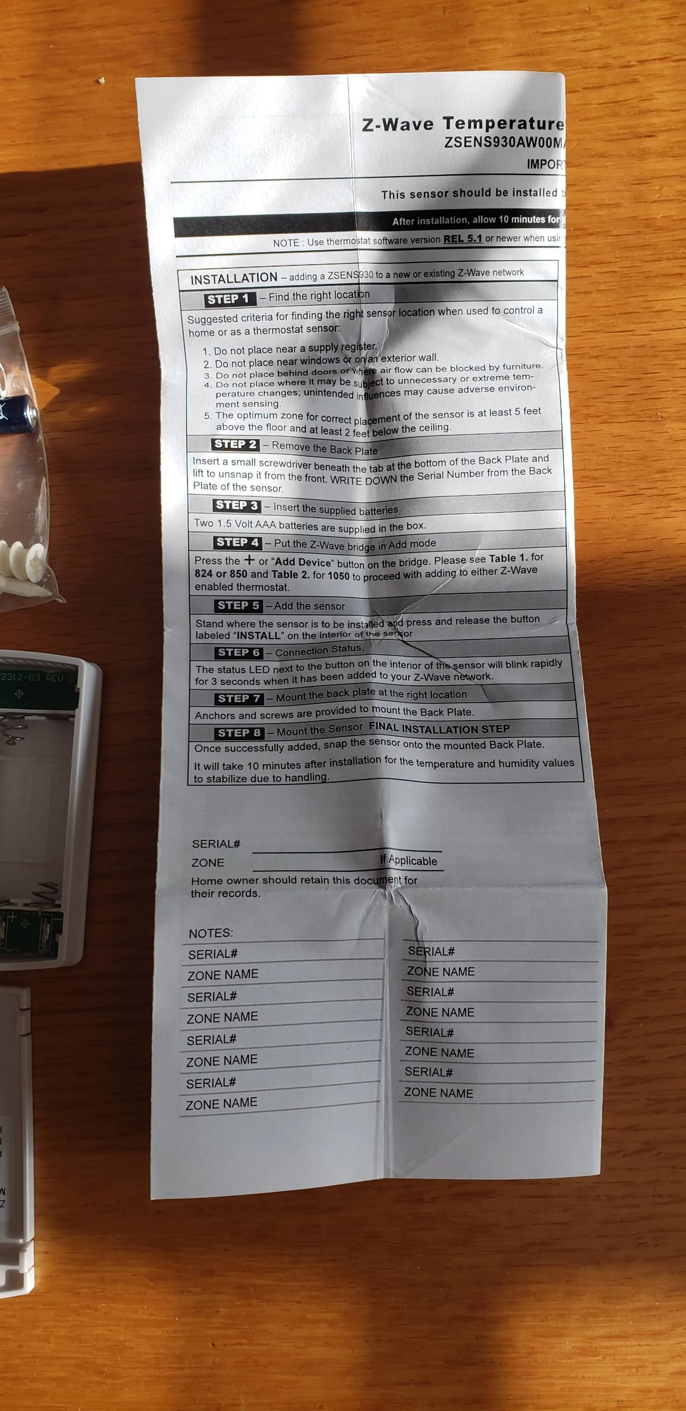Printed wireless sensor instructions unfolded on a table