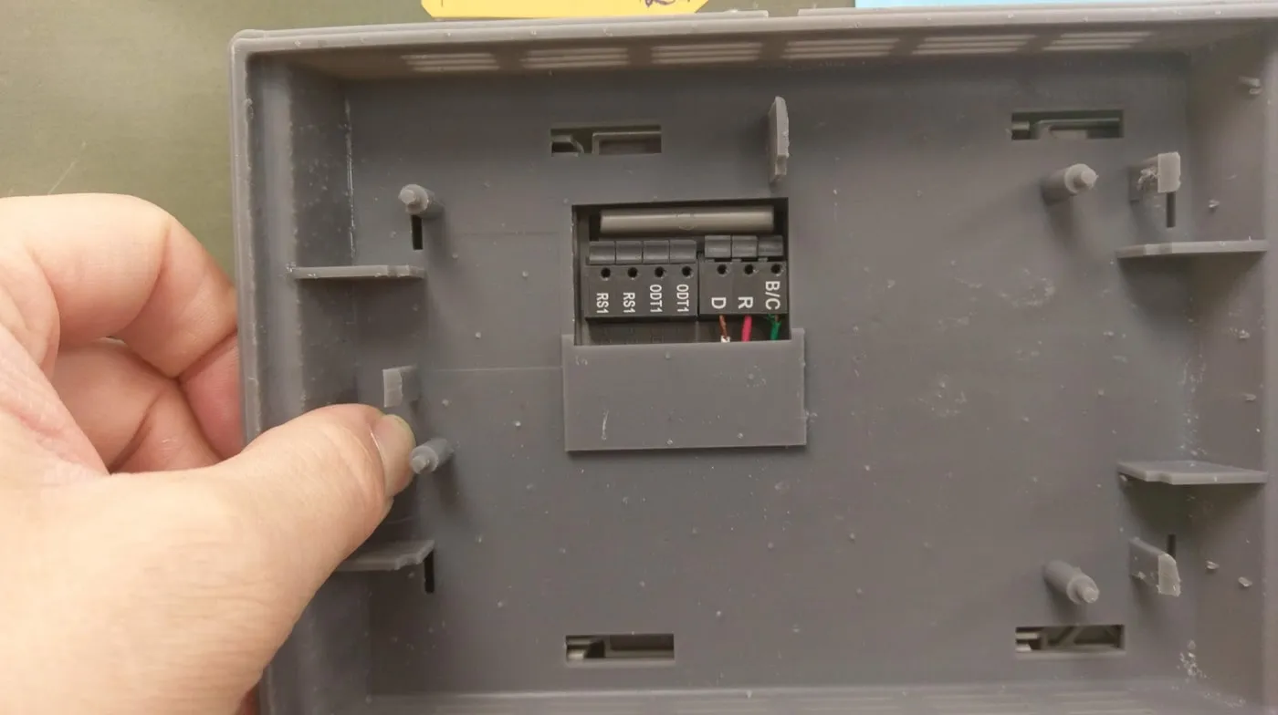 Hand holding a 3D-printed touchscreen enclosure during a fit check