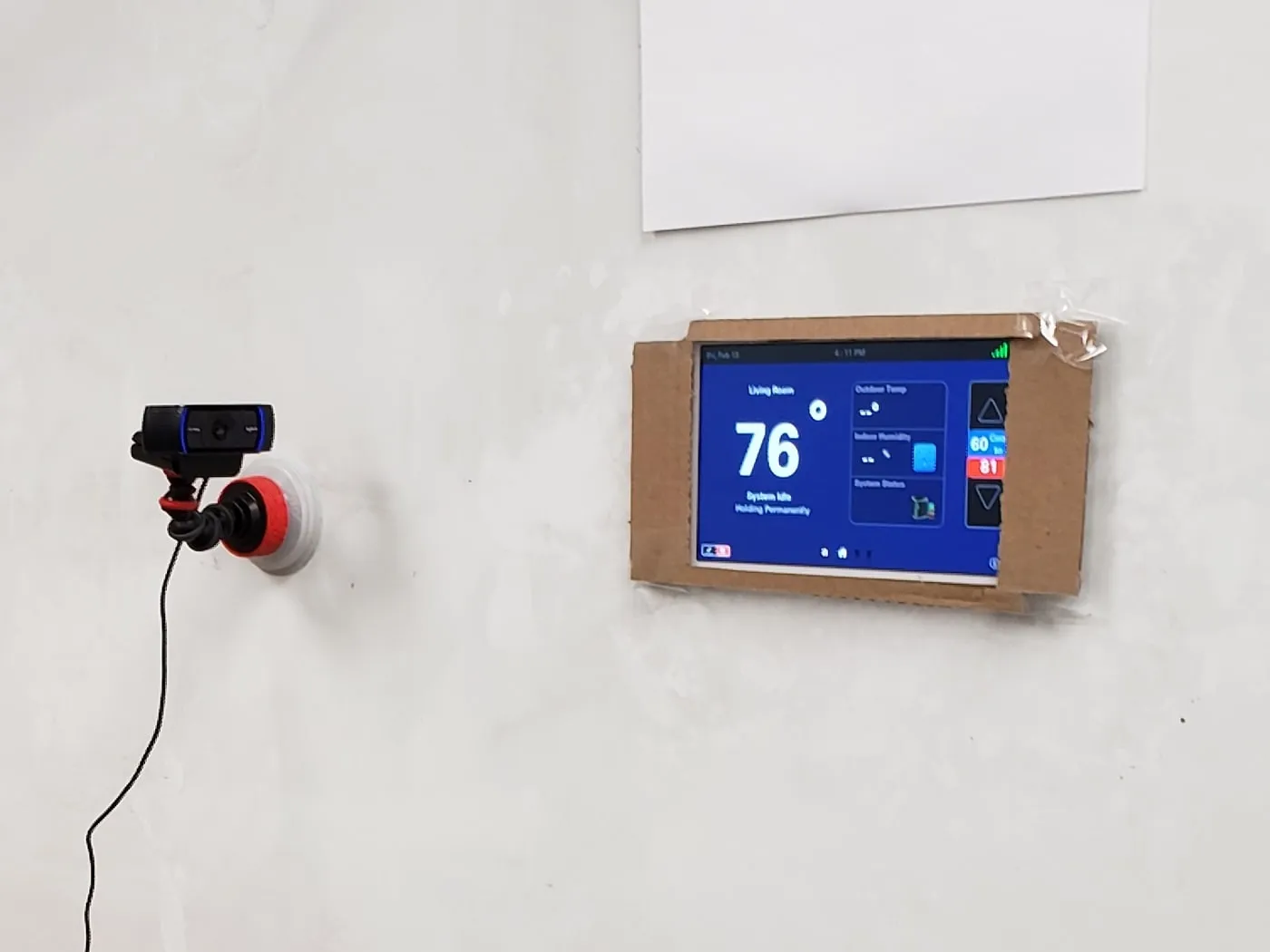 Thermostat usability study rig: a touchscreen mounted on a wall with a camera pointed at it