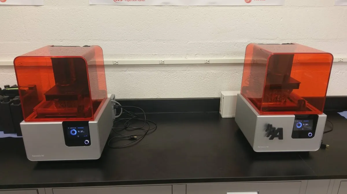 Two 3D printers running in the studio
